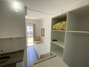 Habitación pequeña con cama y ventana en Pousada Morada das Nações, en Balneário Camboriú