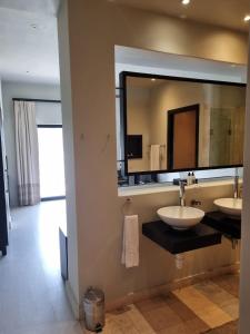 a bathroom with two sinks and a large mirror at Lodge on Lake in Wilderness