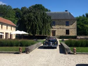 a black car parked in front of a building at Domaine de la Maison Forte in Revigny-sur-Ornain