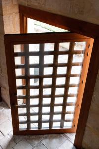 a wooden door with a wooden shutter window at La Maison Forte in Revigny-sur-Ornain