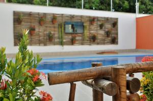 a view of a swimming pool with a wooden fence at OXENTE Natal in Natal
