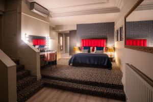 a bedroom with a bed and a desk and stairs at 62 Castle Street Hotel in Liverpool