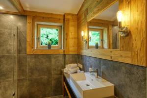 a bathroom with a sink and a mirror at Ferienwohnung Wolf in Fischen