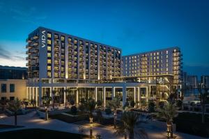 a hotel with a large building at night at Vida Beach Resort Marassi Al Bahrain in Manama