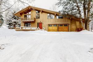 a house in the snow with a driveway at The Clymer House in Teton Village