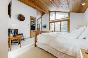 a bedroom with a large bed and a wooden ceiling at The Clymer House in Teton Village