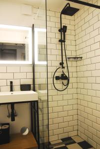 a bathroom with a shower and a sink at Loft Apartament ULA in Elblag