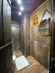 a bathroom with a shower and a toilet at Villa Vinicolla Hospedagem Conceito in Bento Gonçalves