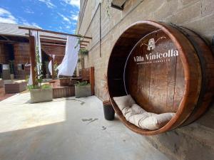 a large wooden barrel sitting on the side of a building at Villa Vinicolla Hospedagem Conceito in Bento Gonçalves