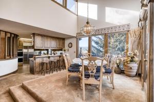 a kitchen and dining room with a table and chairs at Windswept in Angel Fire