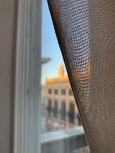 a window with a view of a building at 38 Aira Hotels in Palermo