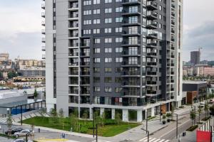 a tall apartment building with a street in front of it at Beograd na vodi - BW ViSTA LUXURY in Belgrade