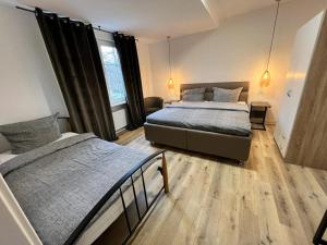 a bedroom with two beds and a couch at Pension-Sendis in Herne +22 photos