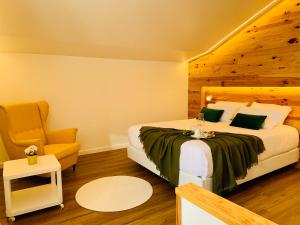 a bedroom with a large bed and a chair at Furnas Spring Lodge in Furnas