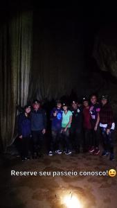 a group of people posing for a picture in a cave at Canto do Sabiá PETAR Hospedagem Familiar in Iporanga