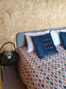 a bed with a pillow that says take your time at Refúgio do Sobreiro in Cabeceiras de Basto +12 photos