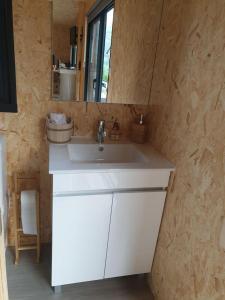 a bathroom with a white sink and a mirror at Refúgio do Sobreiro in Cabeceiras de Basto