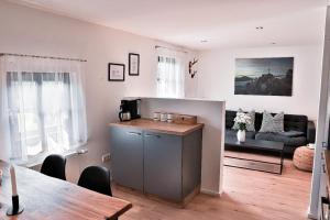 a kitchen and living room with a table and a couch at Roblhof in Drachselsried