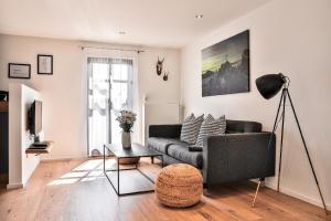 a living room with a couch and a table at Roblhof in Drachselsried