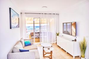 a living room with a couch and a table at 2BDR Comfy Apartment with Ocean View in Poris de Abona