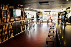 a bar with chairs and tables in a room at Generator Copenhagen in Copenhagen