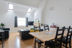 a dining room and living room with a table and chairs at Fantastic 3 Bed Brighton House- Sleeps 6- SUPERFAST WiFi and Garage in Brighton & Hove