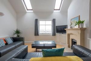 a living room with a couch and a fireplace at Fantastic 3 Bed Brighton House- Sleeps 6- SUPERFAST WiFi and Garage in Brighton & Hove