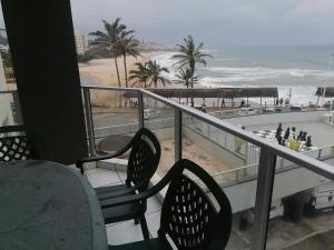 a balcony with chairs and a view of the beach at Seagull Beach resort flat number 313 in Margate