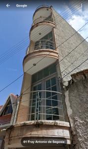 a building with a tower with a large window at Hotel San Salvador in San Juan de los Lagos