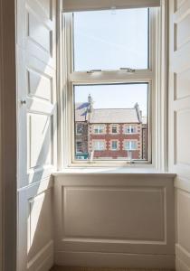 a window with a view of a building at Greco's Close in Dunbar