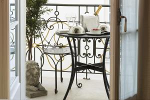 a black iron table with a tea set on it at Hôtel Da Vinci & Spa in Paris