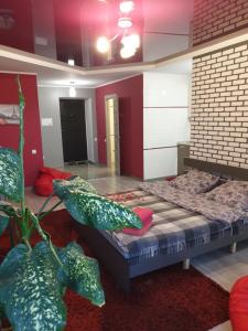 a bedroom with a bed with pillows on it at Стильна квартира-студія в центрі міста на набережній in Ternopilʼ