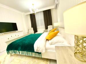 a bedroom with a bed, chair, and nightstand at DeLight Apartments in Boryspil