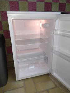 an empty refrigerator with its door open in a kitchen at Monteur Apartment Victoria in Hagen