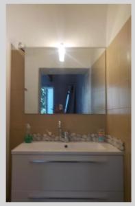 a bathroom with a sink and a large mirror at FRAROCKA B and B in La Ciotat