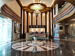 a lobby with a table and a chandelier at Inspira Resort & Spa in Silvassa