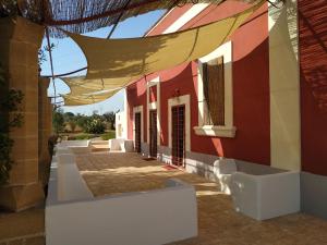 a red and white building with a roof at Casina Rossa di Pietrafitta in Casarano