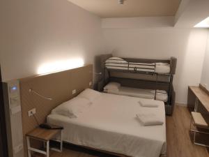Postel nebo postele na pokoji v ubytování Albergo Baschera
