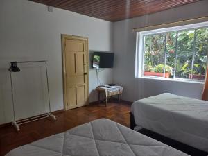En eller flere senge i et værelse på Villa Amada a place to relax and take a rest