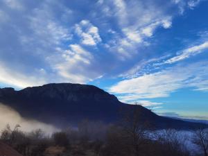 a view of a mountain with fog in the valley at Konak -Guest house -Ramonda Serbika in Niš