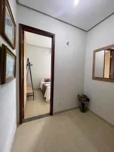 a room with a door leading to a bedroom at Village Brasil, Lençóis in Lençóis