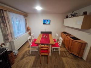 a kitchen with a table and chairs in a room at Chalupa Agáta in Herálec