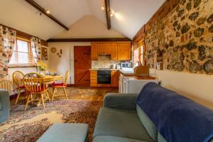 a living room with a couch and a table at Laburnum Holiday Cottage in Tunstead