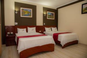 Postelja oz. postelje v sobi nastanitve Hotel Suite Naylamp Zyon