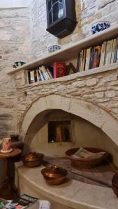 a stone fireplace with bowls on top of it at a trip to the past and the beauty in Koumeika