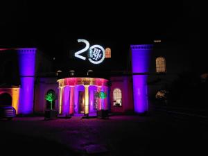 a building with blue and purple lights on it at Moggerhanger Park, Moggerhanger in Sandy