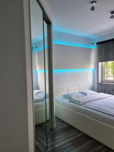 a bedroom with a bed and a mirror at Apartament Exclusive in Poznań