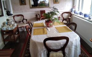 a dining room with a table with a plant on it at Brookside in Allonby