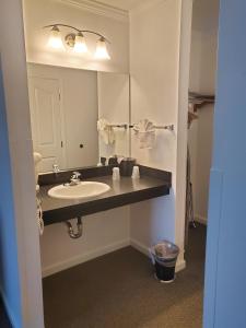 a bathroom with a sink and a mirror at Signature Hotel by Tachi in Hanford +10 photos