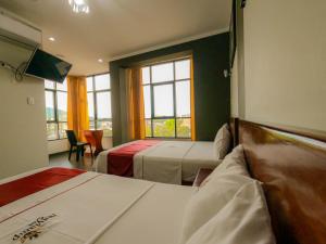 Postel nebo postele na pokoji v ubytování Hotel Suite Naylamp Zyon